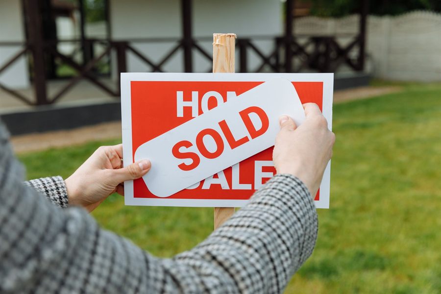 Sold sticker on a for-sale sign